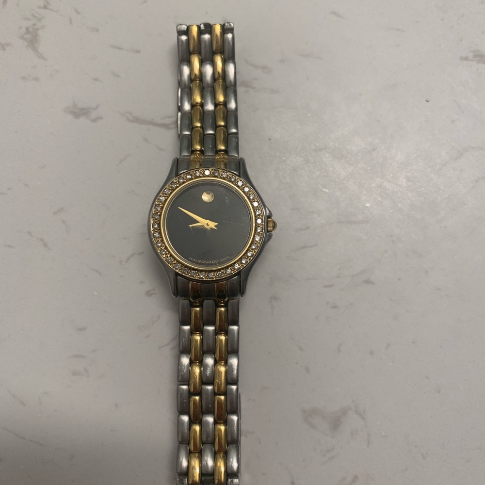 Women’s Movada gold watch with diamond bezel